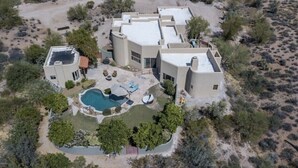 A modern, multi-story house with a swimming pool, surrounded by desert vegetation. - Casa Carefree 3 Bedroom Home by RedAwning (Carefree)