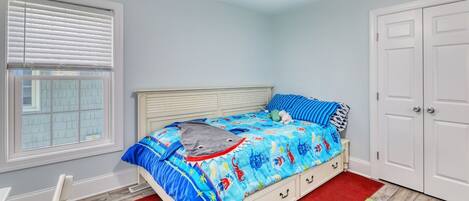 A bedroom with a bed, a window with blinds, a ceiling fan, and a door.