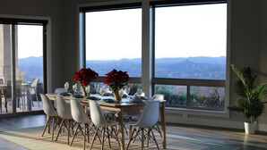 A dining area with a table set for six, large windows, and a view of mountains. - San Diego Wine Country Pool, Views, 4BR (Ramona)