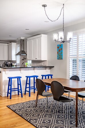 Enjoy meals in the kitchen and dining area, featuring a range, cabinetry, and a dining table with chairs.