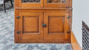 A wooden cabinet with glass doors and metal handles. - Niagara Falls Home 2BR, Pets OK, Free Parking (Niagara Falls)