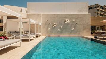 A modern pool area with lounge chairs and a minimalist design.