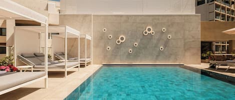 A modern pool area with lounge chairs and a minimalist design.
