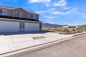 Two-story house with attached garages and a scenic view.