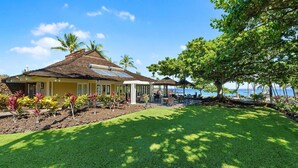 A house with a covered patio, a lawn, and a view of the ocean. - Big Island Golf Villas A1 3 Bedroom Condo (Kamuela)
