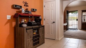 A coffee bar with a sign reading "Coffee Bar" and "Coffee Time," a coffee machine, a kettle, and a coffee pot on a wooden counter. - Spacious Route 66 retreat. Golf Course. Pet Friendly. Grand Canyon and Vegas. (Kingman)