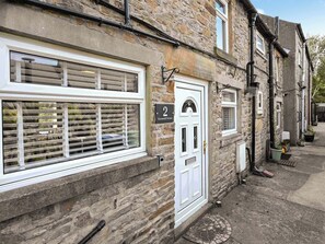 A stone building with a white door labeled "2 Greenwell Terrace." - 2 bedroom accommodation in Frosterley, County Durham (Frosterley, County Durham)