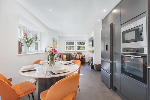 Open-plan kitchen and dining area with quartz table