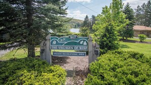 A sign for 'The Villages of Wisp' indicating a private recreational area. - New! Mountain View Chalet w/ Hot Tub & Fireplace (McHenry)
