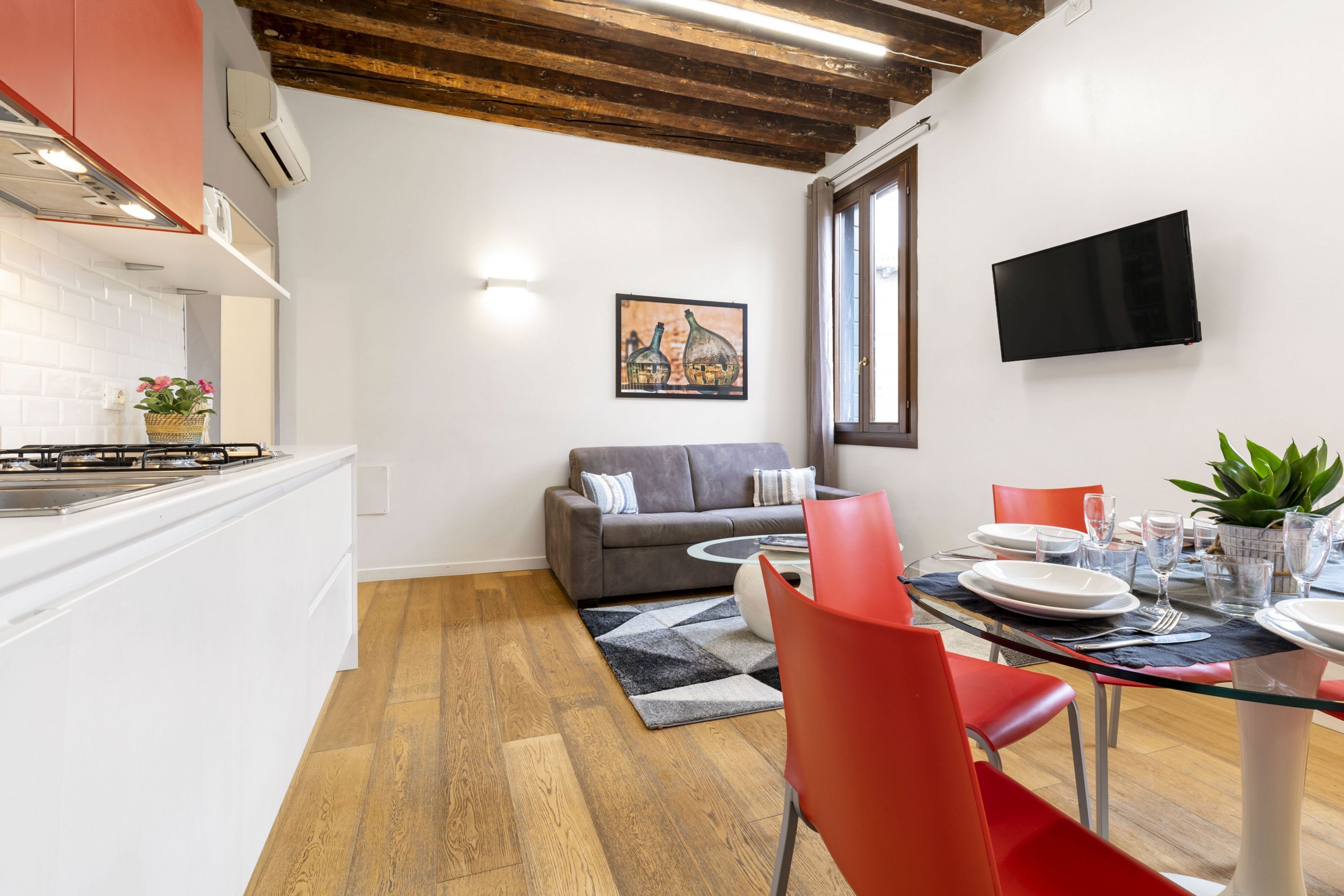 A compact living space with a kitchen, dining area, and seating area.