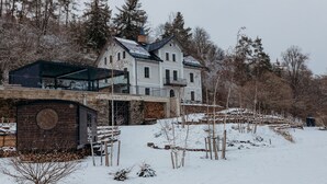 A large, white, multi-story house with a modern extension featuring large glass windows. - Wmm020 in Manet n With 7 Bedrooms and 8 Bathrooms (Manětín)