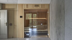 A modern interior with a wooden wall, a white door, and a bench area with a glass partition. - Wmm020 in Manet n With 7 Bedrooms and 8 Bathrooms (Manětín)