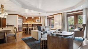 A spacious living area with a kitchen, dining table, and seating arrangements.