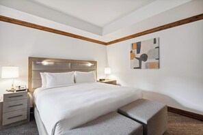 A hotel room with a large bed, bedside tables, a bench, and a wall-mounted abstract art piece. - The Aspen Mountain Residences 24A - Studio Residence (Aspen)