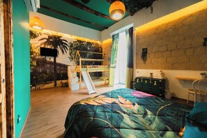 A room with a bunk bed, a desk, a chair, a window with curtains, a wall-mounted TV, and a ceiling light fixture. - La Casa di LùAle e Zoe (Naples)