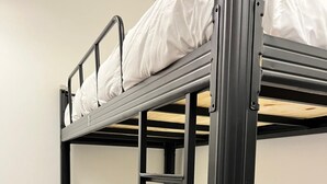 A bunk bed with white bedding and a ladder. - Pine Armenian (George Town)