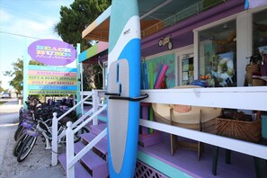 A colorful beach-themed storefront with a sign listing rentals like kayaks, golf carts, and bikes. - Spacious Pet Friendly 3BR Home W/ Private Pool & Spa in Palma Sola (Bradenton)