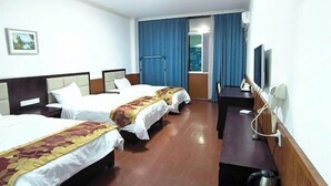 A hotel room with two beds, a desk, a chair, a TV, and a window with curtains. - Yichun Yue Hotel (Yichun)