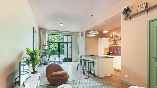 Eine moderne Wohnung mit Wohnbereich, Küche und Essbereich.