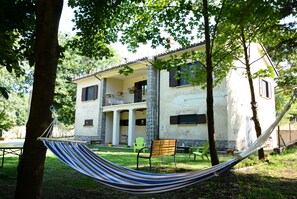A two-story building with a balcony, a hammock, and outdoor seating. - Casale Trifoglio (Morano Calabro)