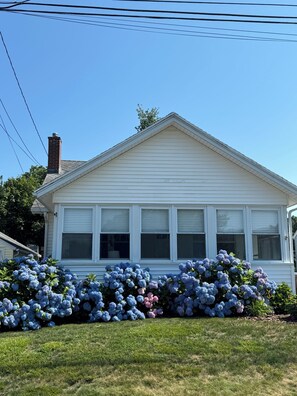 A white house with a gabled roof and a brick chimney. - 4-BdRm Home at Black Point Beach, East Lyme - WiFi + AC, Pet Friendly! (East Lyme)