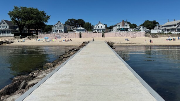 A pier leading to a beach with houses in the background. - 4-BdRm Home at Black Point Beach, East Lyme - WiFi + AC, Pet Friendly! (East Lyme)