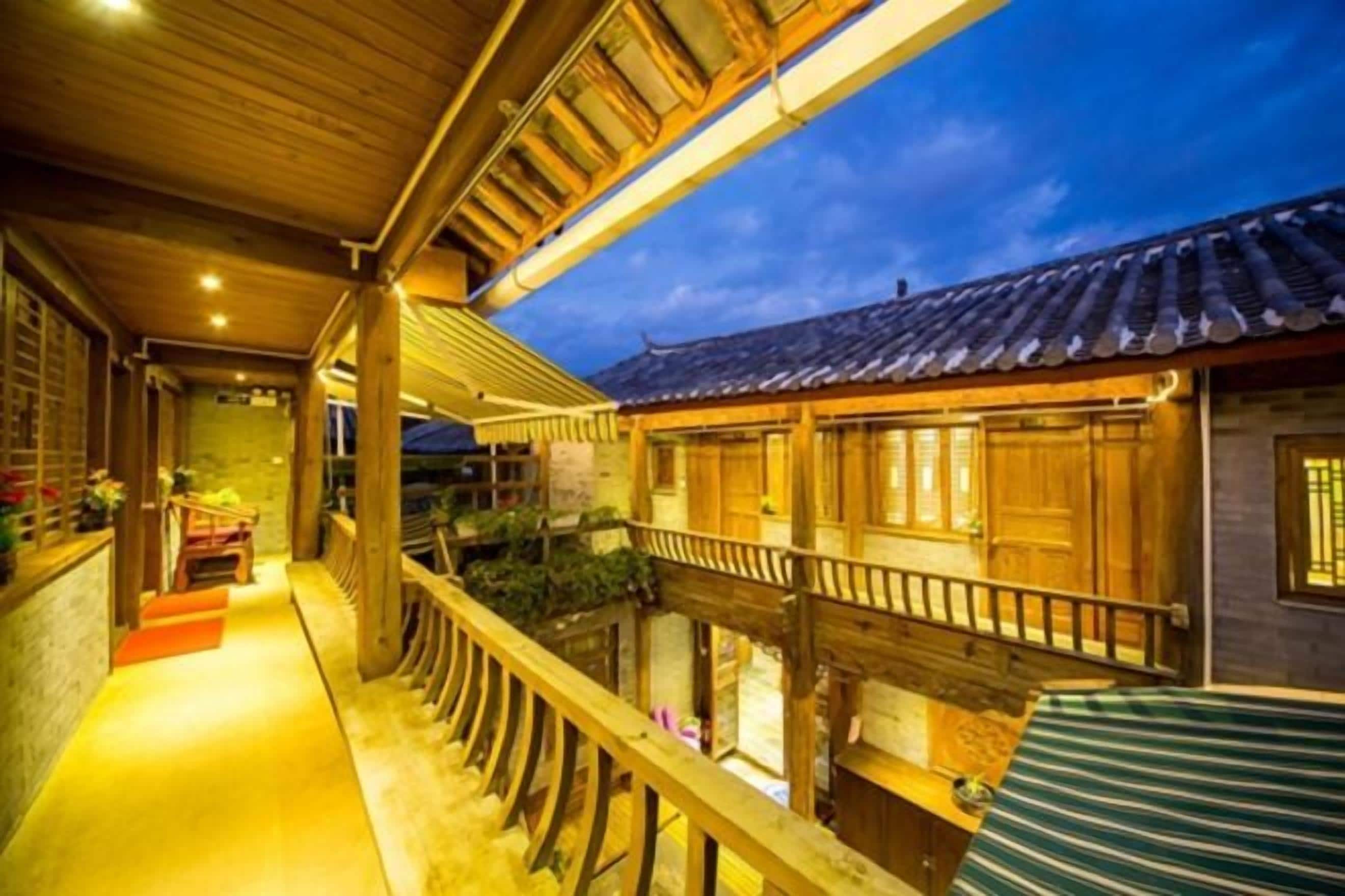 A traditional wooden building with a balcony, wooden railings, and a tiled roof.