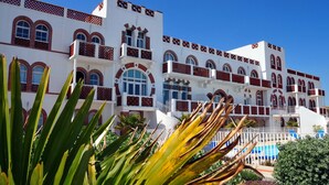 A multi-story hotel with balconies, large windows, and a pool area. - Appart avec accès Direct Plage, à 50m du Centre (La Tranche-Sur-Mer)