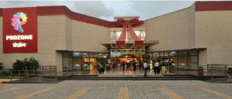 A building with a large red sign reading "PROZONE" and a prominent red bow above the entrance.