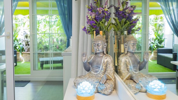 A room with a Buddha statue, a vase with flowers, and a modern interior design. - Cubo’s Poseidon Suites 3 & Pool for Adults / room / air conditioning / community pool / free wifi (Benalmádena)