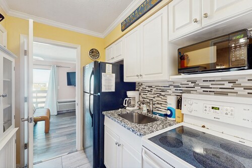 Modern condo close to beach with pool, hot tub, & water view