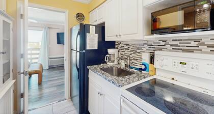 Modern condo close to beach with pool, hot tub, & water view