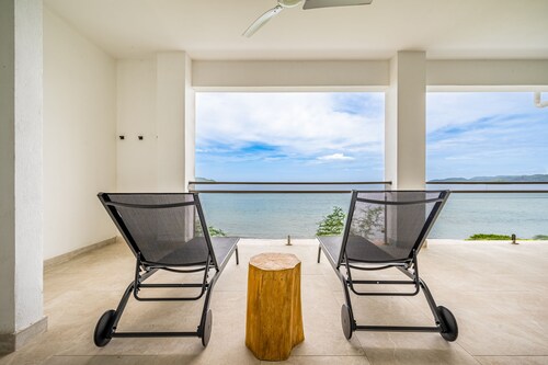 Spacious waterfront condo with shared pool, balcony, and washer/dryer