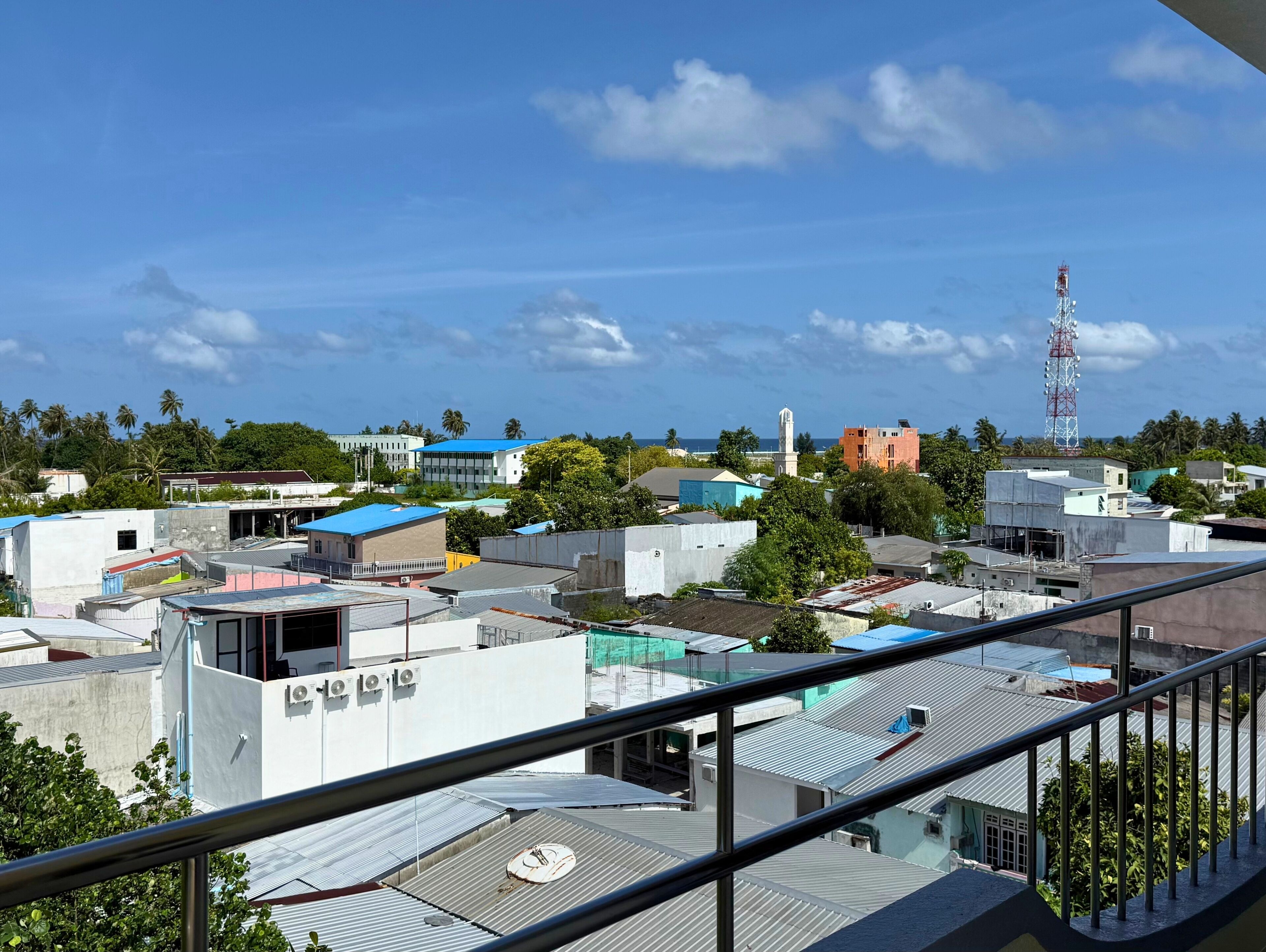 A residential area with various buildings, including a prominent tower and a mosque.