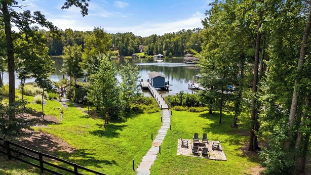 A lakeside property with a dock, grassy areas, and a walking path. - Lakefront Lake Anna, Dock, Views, Deck, Movies (Mineral)