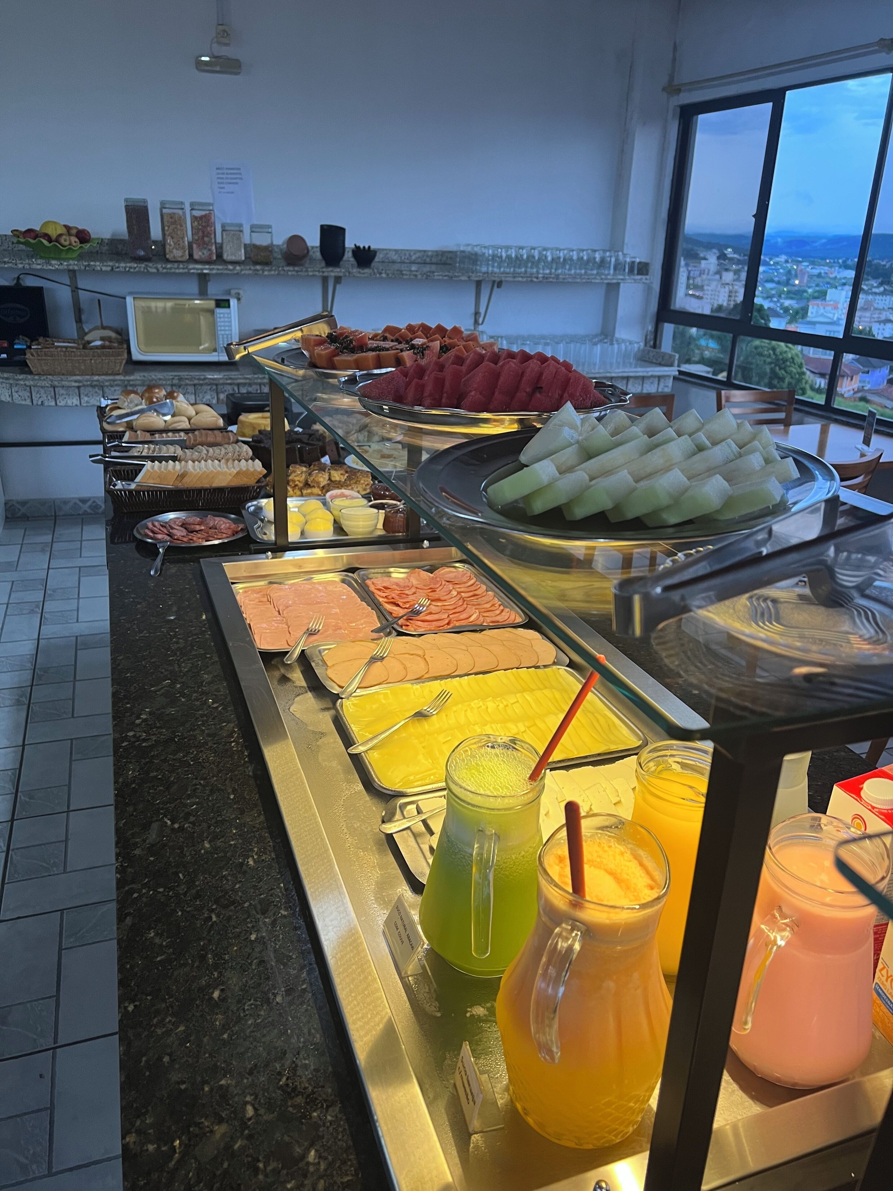 A buffet with various food items and beverages.