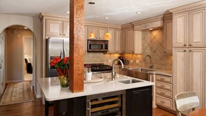 A modern kitchen with a central island, stainless steel appliances, and a built-in dishwasher. - Cozy Condo in Snowmass Village (Snowmass Village)