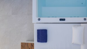 A modern bathroom with a built-in bathtub, a wooden cabinet, and a towel rack. - Sapphire Zafeirenias Gem House With Jacuzzi (Hersonissos)