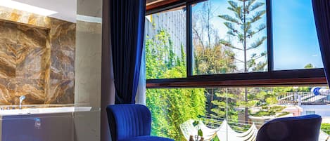 Deluxe Suite, Courtyard View | Minibar, in-room safe, individually decorated, desk