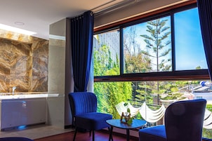 Deluxe Suite, Courtyard View | Minibar, in-room safe, individually decorated, desk