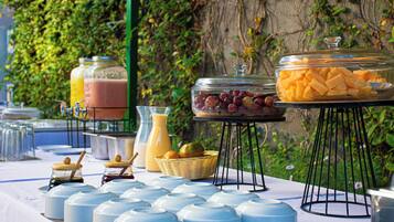 A buffet table with various food items and condiments.