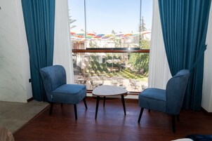 Deluxe Suite, Courtyard View | Minibar, in-room safe, individually decorated, desk