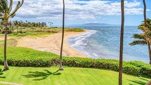 A golf course with a beach view, palm trees, and a clear sky. - Beautifully Upgraded, Amazing Ocean Views MS316 (Kihei)