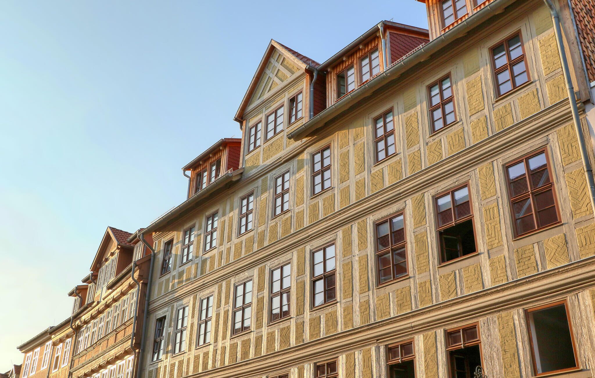 A multi-story building with a traditional architectural style, featuring a symmetrical facade with evenly spaced windows and decorative elements.