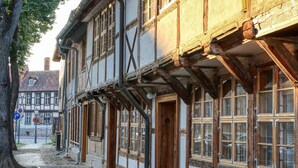 A traditional half-timbered building with exposed wooden beams and a cobblestone street.