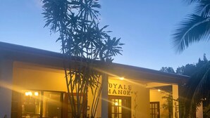A building with a sign reading "ROYAL MANOR". - 1 Bedroom Canal Cottage, Pool, Fishing, BTB Approved, Quiet, Bikes, Kit, Laundry (Corozal Town)