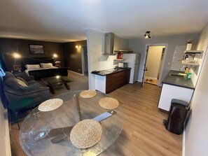 A modern apartment with a living room, dining area, and kitchen. - Close To Whyte University New Renovati (Edmonton)