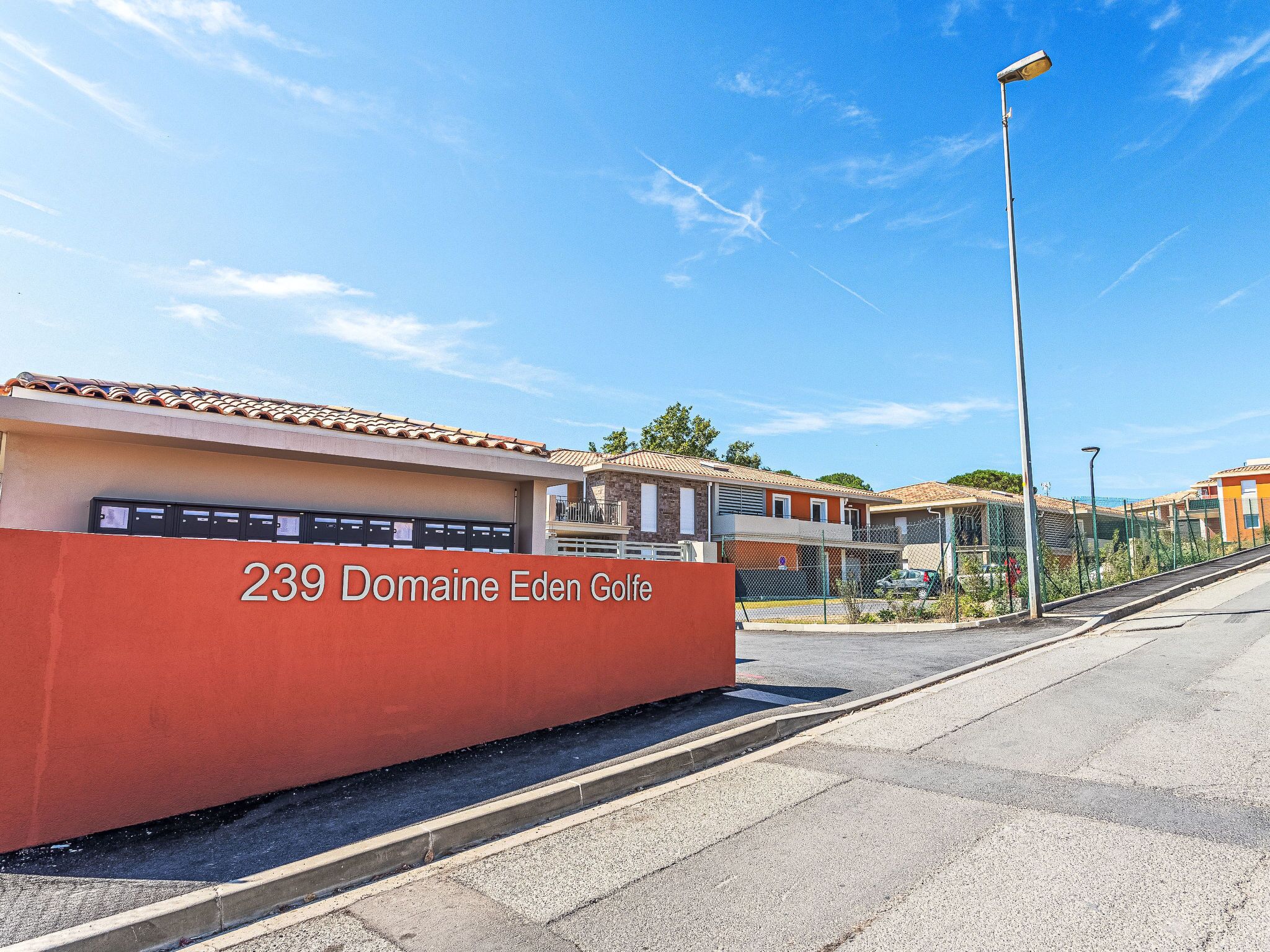 A building with a sign reading '239 Domaine Eden Golfe.'
