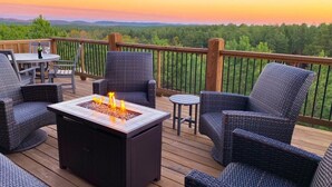 A deck with wicker furniture, a fire pit, and a view of the landscape. - Mountain Views, Hot Tub, Arcade, Pets, More Than A View (Broken Bow)