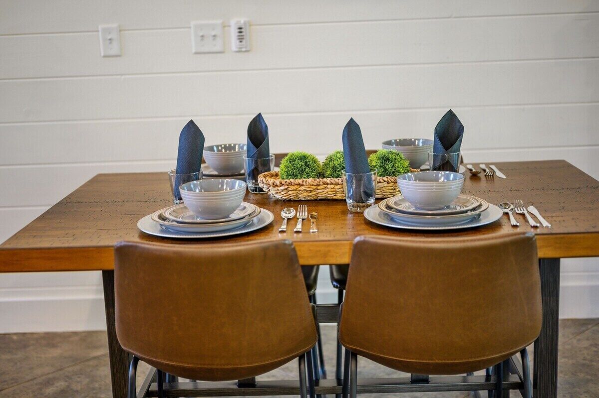 A dining table set with plates, bowls, and cutlery.